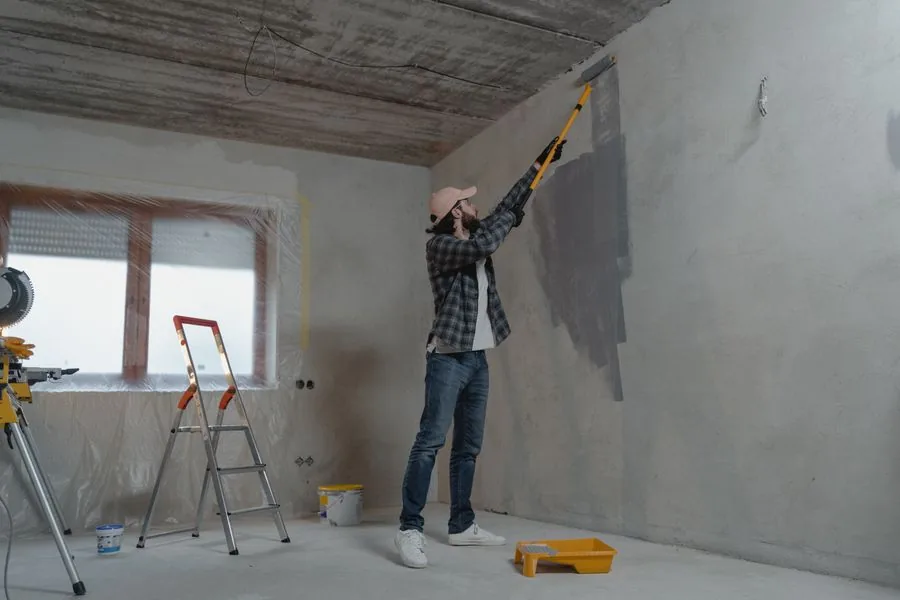 A pro rolling fresh paint onto an interior wall